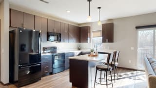 Furnished apartment kitchen with dark finish style and all black kitchen appliances