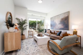 Furnished living room with walk out balcony access