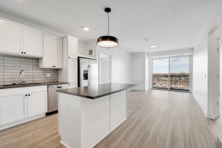TheRowanLuxuryApartments Large kitchen with countertop island white cabinets and matching stainless steel appliances at The Rowan Apartments in Eagan Minnesota