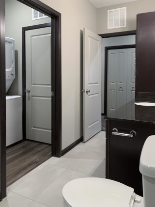 Bathroom with dark brown vanity and large mirror