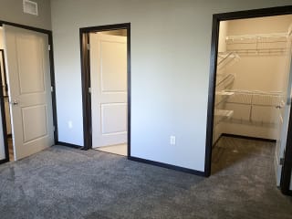 master bedroom with access to walk in closet and private bathroom