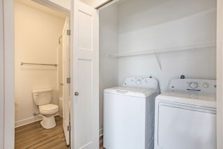 a washer and dryer in a room with a toilet