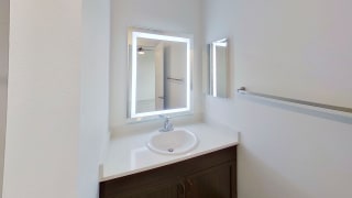 a bathroom with a sink and a mirror a bathroom with a sink and a mirror at Meadowbrooke Apartment Homes, Grand Rapids, Michigan