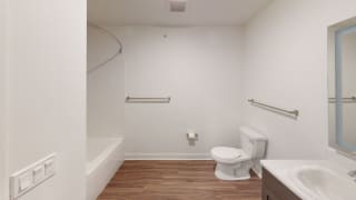 a bathroom with a toilet and a sink and a bath tub a bathroom with a toilet and a sink and a bath tub at Meadowbrooke Apartment Homes, Grand Rapids, 49512