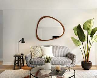 a living room with a couch and a mirror on the wall