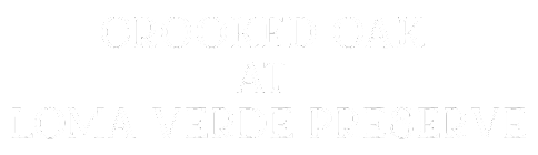 A green sign with white text that reads "Crooked Oak at Loma Verde Preserve".