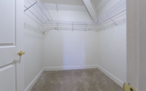 a empty room with white walls and a white closet