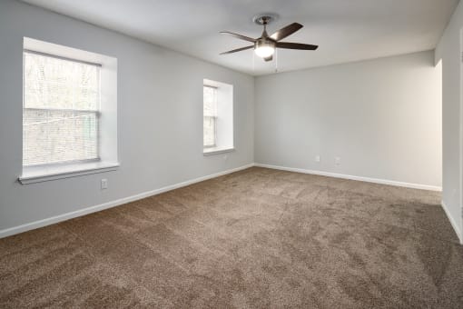 an empty kitchen with wooden cabinets and a window