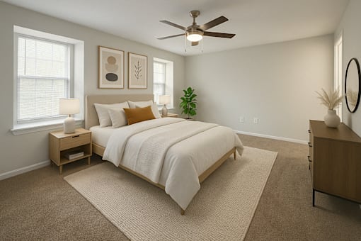 A bedroom with a large bed and a ceiling fan.