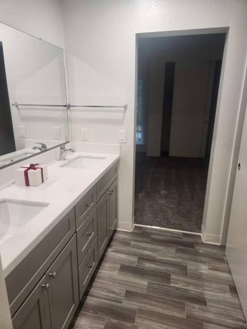 A bathroom with a white sink and a mirror.