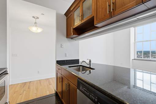 A kitchen with wooden cabinets and black appliances.