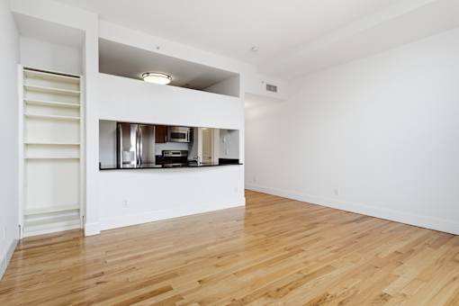A kitchen area with a refrigerator, microwave, and oven.