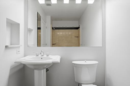 A white sink and toilet in a small bathroom.