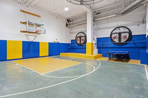A basketball court with a blue and yellow color scheme.
