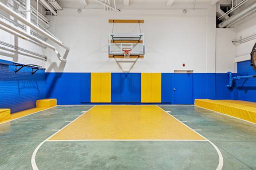 A basketball court with a blue and yellow color scheme.