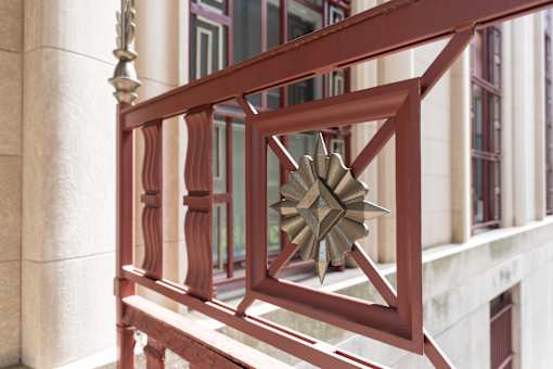 A red railing with a star decoration on it.