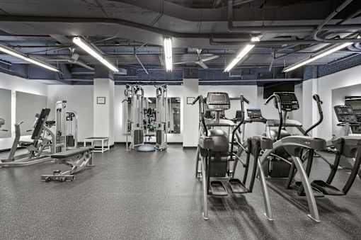 A gym with a variety of exercise equipment.