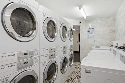 A row of LG washing machines in a laundromat.