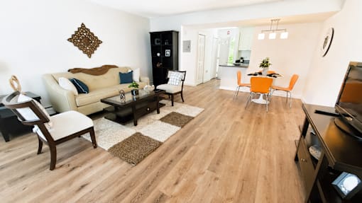 A living room with a sofa, chairs, and a coffee table.