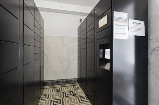 A hallway with a marble floor and walls, and a sign that says amazon.