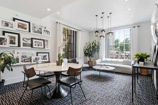 A modern living room with a round table and chairs.