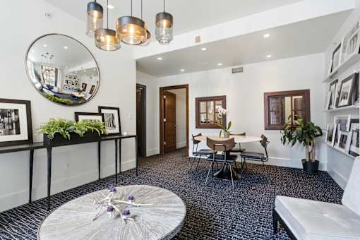 A modern living room with a round mirror and a white sofa.