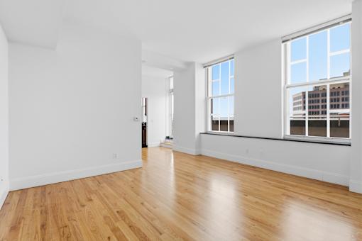 A room with wooden floors and white walls.