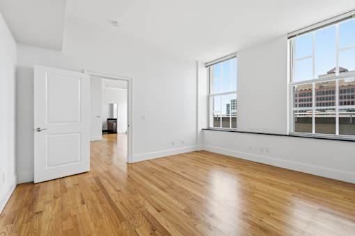 A room with wooden floors and white walls.