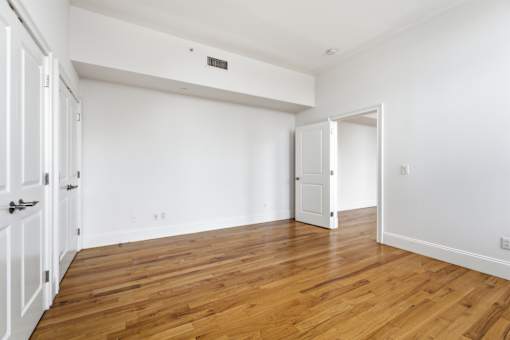 A room with wooden floors and white walls.
