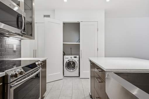 A modern kitchen with a stove top oven, microwave, and a dishwasher.