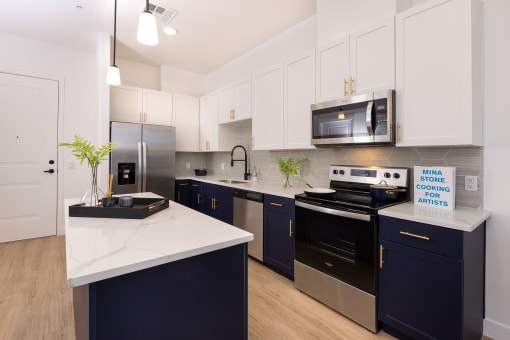 model apartment kitchen with cabinets and quartz countertops
