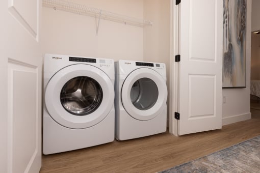 a washer and dryer sit next to each other in a laundry room