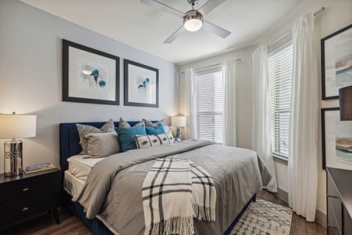 a bedroom with a large bed and a ceiling fan at LynnCora, Grand Prairie, Texas