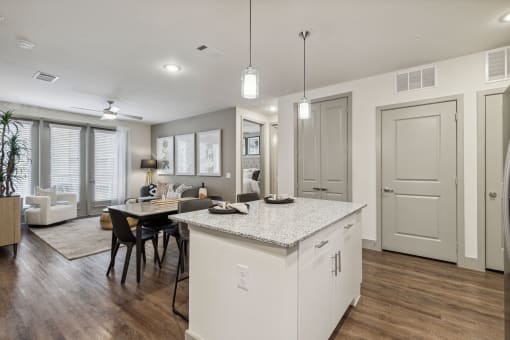 an open kitchen and dining room with a table and chairs and kitchen island at LynnCora, Texas, 75052