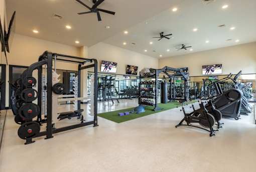 A well-equipped gym with a variety of machines and weightlifting equipment.