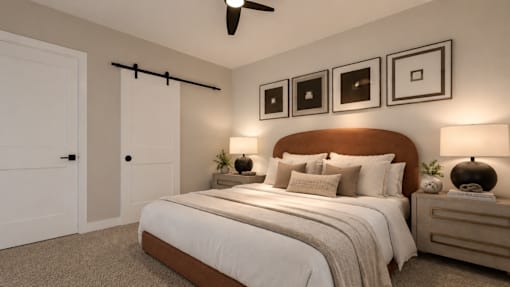 A bedroom with a bed, nightstands, and pictures on the wall and ceiling fan.