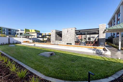 A modern building with a Bocce Court in front