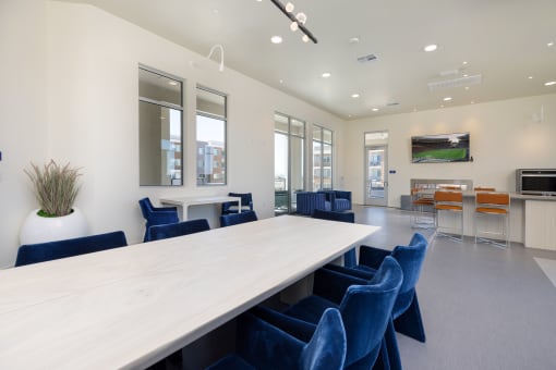 a conference room with a long table and blue chairs