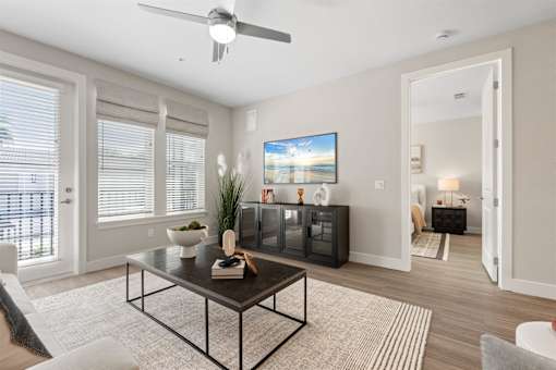 an open living room with a ceiling fan and a table at Mira at Palmer Ranch, Sarasota, FL, Florida