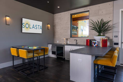 a kitchen and dining area in a social space at solasta apartments