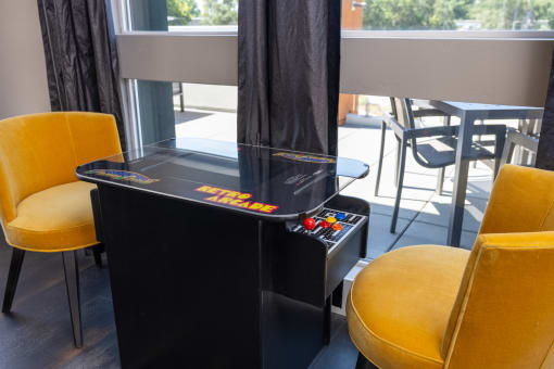 a game table in a room with yellow chairs at Solasta, Sacramento, CA, 95831