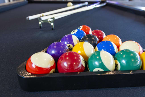 a game of billiards on a pool table at Zeta Luxury Apartments in Sacramento, CA