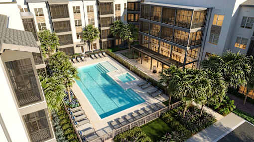 A swimming pool surrounded by palm trees and buildings.