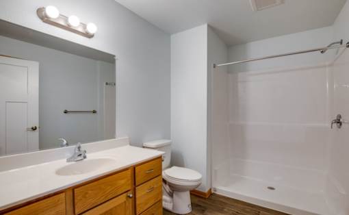 A white bathroom with a sink, toilet, and bathtub.