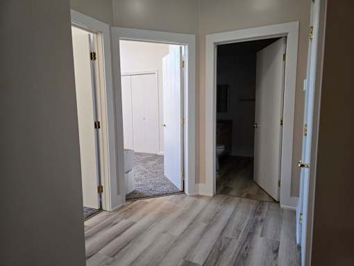 A room with a white door and a white wall.