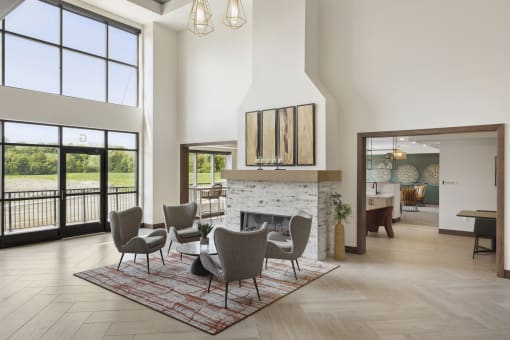 a living room with a fireplace and a dining room in the background