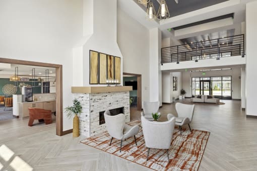 a living room with a fireplace and a staircase in the background