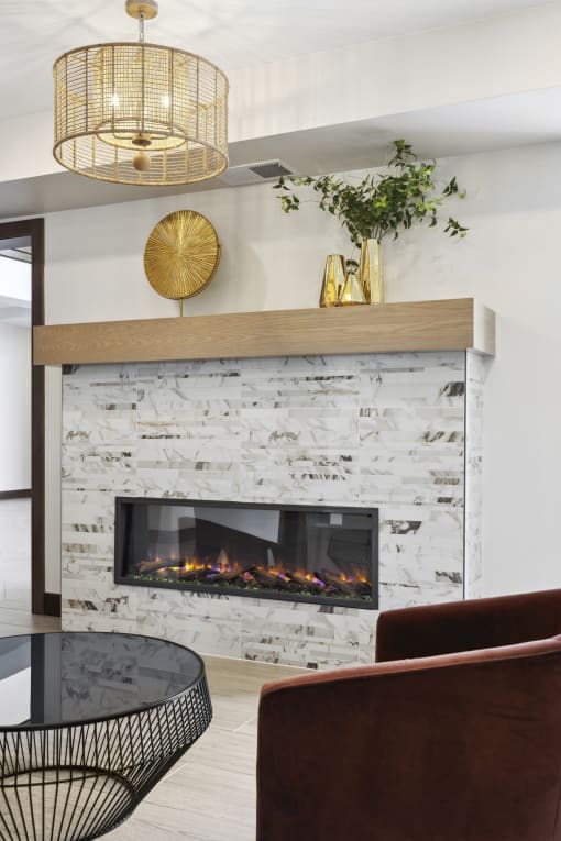 a living room with a fireplace and a round table