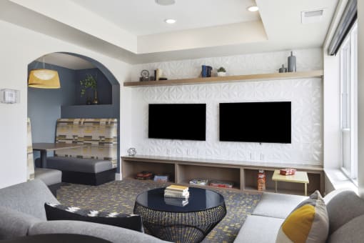 a rendering of a living room with two televisions and a coffee table