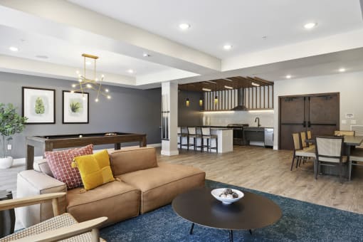 a living room with a couch table and chairs